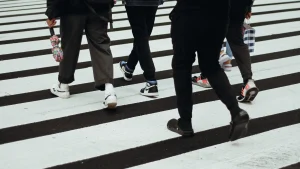 People walking across a crosswalk.
