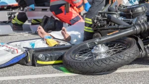 Paramedics assisting injured person after motorcycle accident